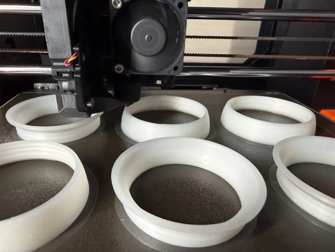 Six ball halves printing open-side-down on the bed, threaded rims facing up